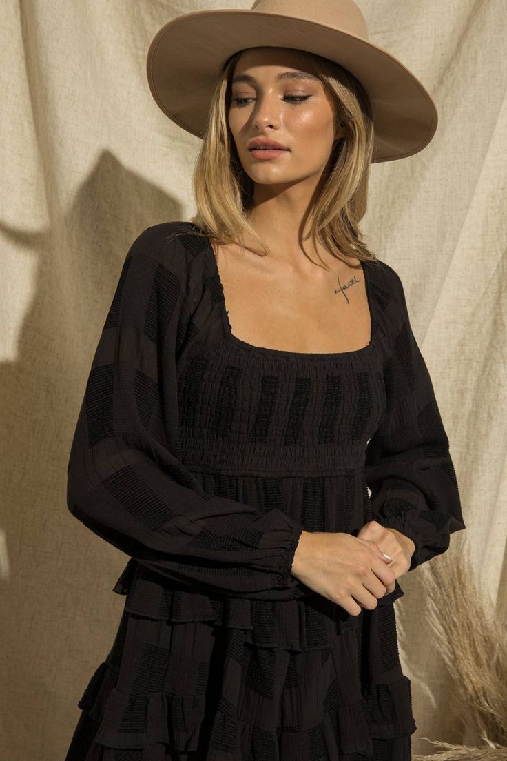 -Color: Black -Square neck -Long sleeves -Smocked top -Ruffle tier -Lined -Content: 90% Cotton 10% Polyester -Imported -Runs true to size -Model is wearing a size Small Black Smocked Top With Ruffles For Day Out, Chic Smocked Top With Square Neck And Elastic Sleeves, Black Long Sleeve Smocked Top, Black Long Sleeve Smocked Top With Ruffles, Square Neck Smocked Top For Brunch, Chic Black Smocked Dress With Long Sleeves, Chic Black Long Sleeve Smocked Dress, Black Smocked Bodice Top With Square Neck, Chic Smocked Dress With Square Neck And Smocked Cuffs