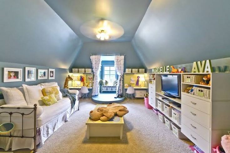 a bedroom with blue walls and carpeted flooring, built in bookshelves