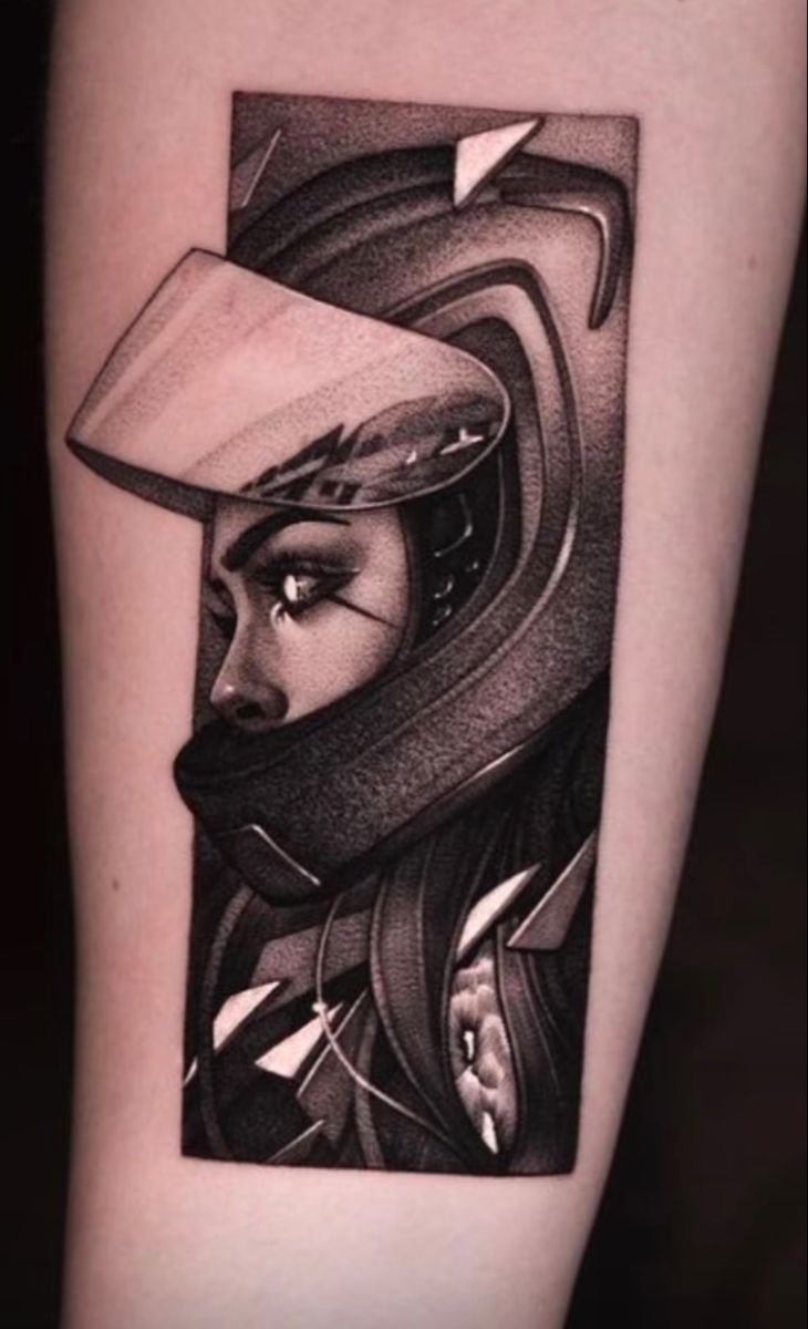 a black and white tattoo with a woman wearing a helmet on her arm, looking at the viewer