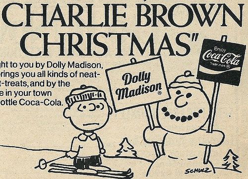 an advertisement for coca cola featuring charlie brown and his snowman holding a christmas sign