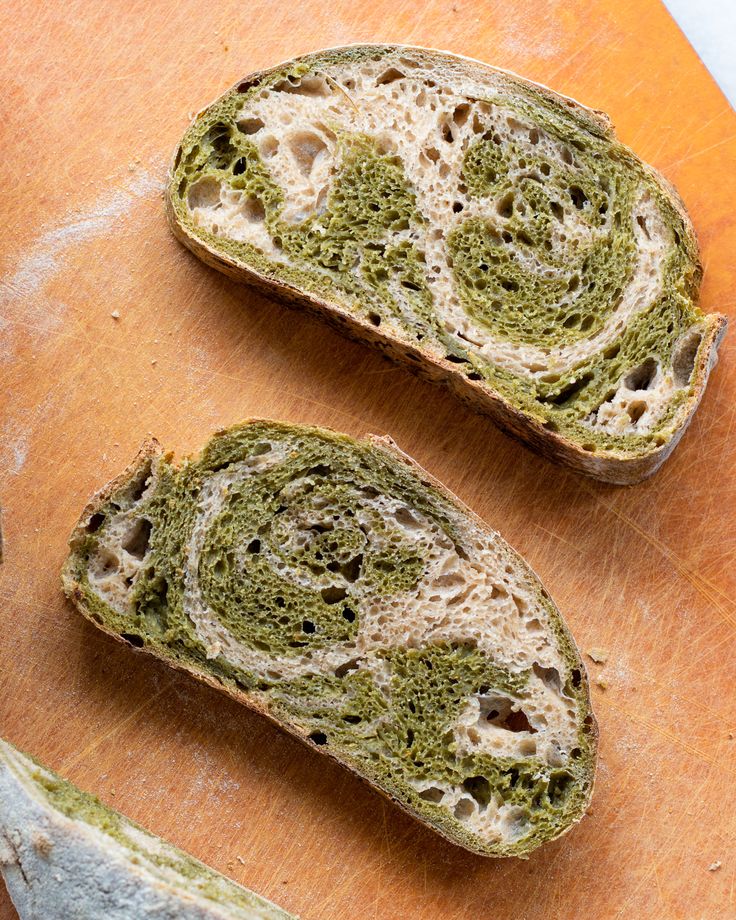 two pieces of bread that are sitting on a cutting board