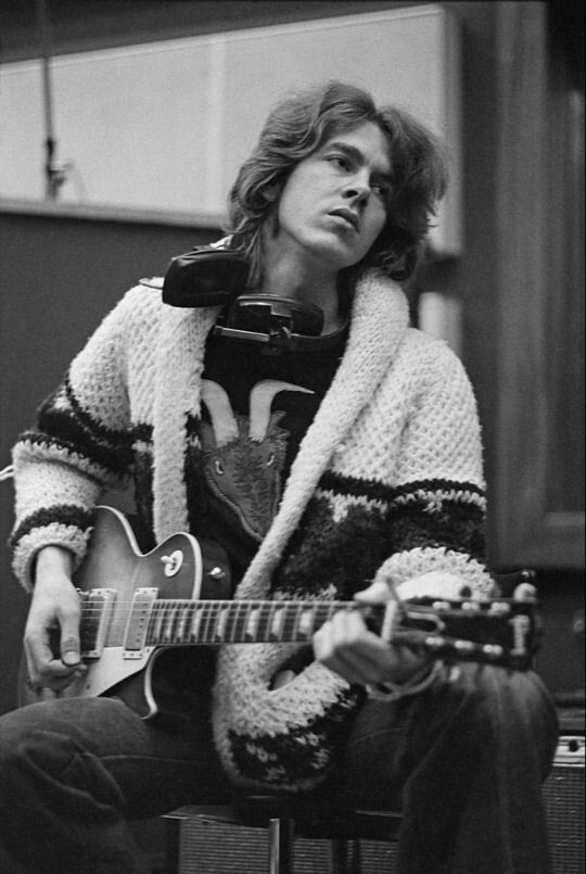 an old photo of a man playing a guitar