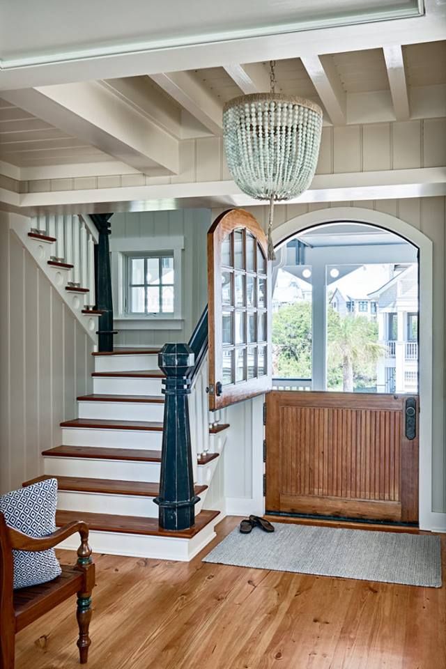 an entry way with stairs and a chandelier