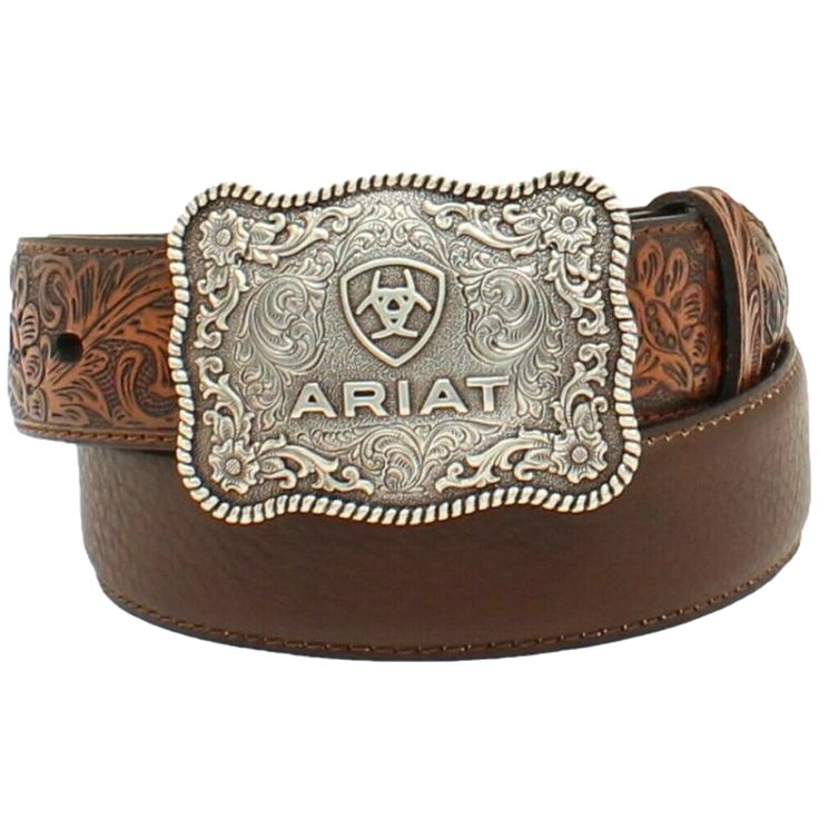 Style number: A1301002 Brown full-grain leather belt. Floral tooled design on billets. 1/4 inch belt width. Antique silver large square belt buckle with scroll filigree and Ariat shield logo and roped scalloped edges. Square Belt Buckle, Tooled Belt, Boys Belt, Little Cowboy, Shield Logo, Tool Belt, Branded Belts, Leather Floral, Western Belts