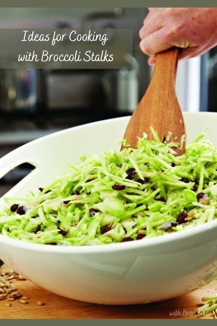 a bowl filled with shredded broccoli sitting on top of a wooden cutting board