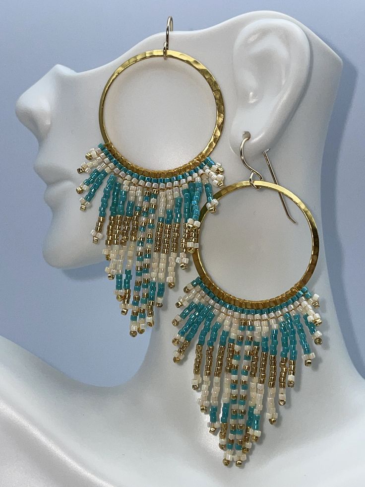 boho hammered gold hoop earrings featuring pearlescent cream, aqua and metallic gold seed beads.  Handmade in a boho tribal pattern. Seed Bead Hoop Earrings, Concert Date, Aqua And Gold, Bead Hoop Earrings, Beading Thread, Boho Patterns, Earrings In Gold, Beaded Hoop Earrings, Beaded Hoops