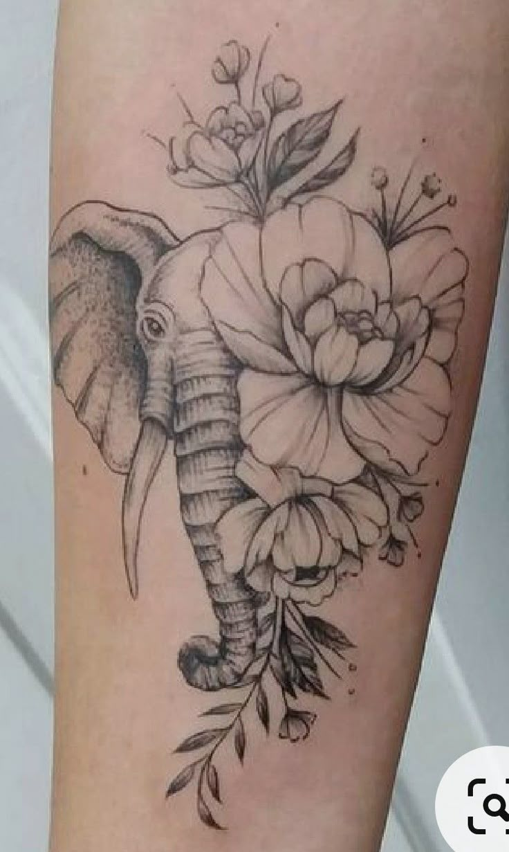 an elephant with flowers on it's leg is shown in black and grey ink