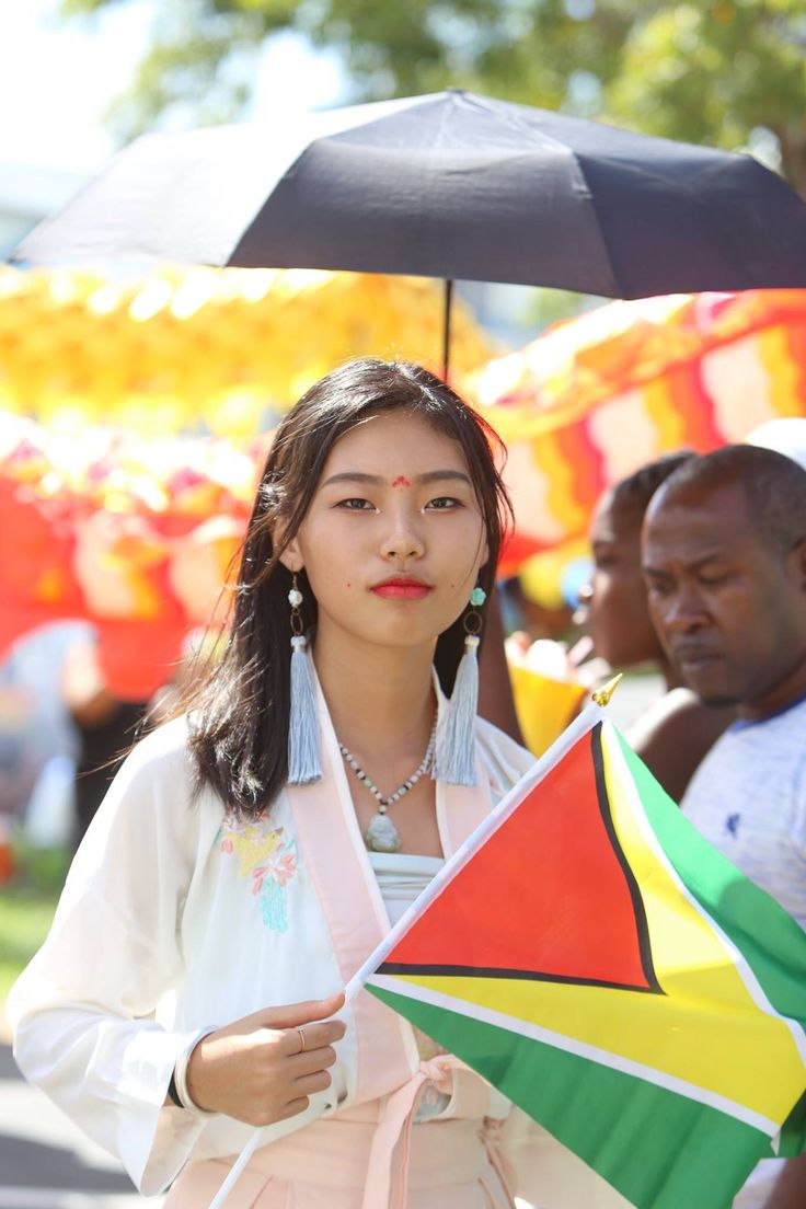 a woman holding an umbrella in front of other people