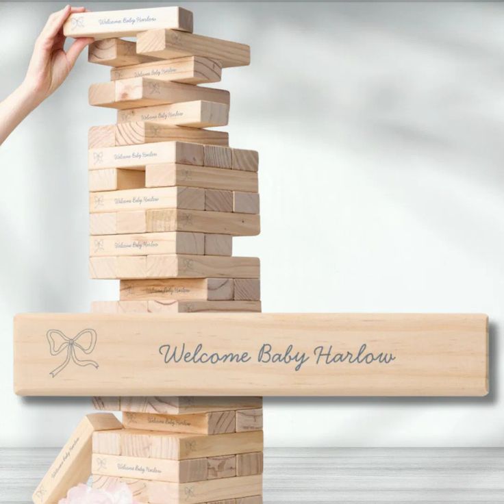 a wooden block tower with the words welcome baby fabulous on it