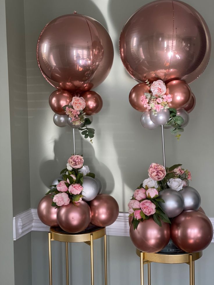 two tables with vases filled with flowers and balloons