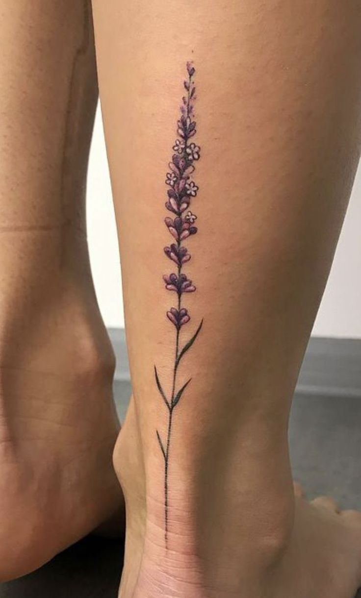 a woman's leg with a small flower tattoo on the back of her thigh