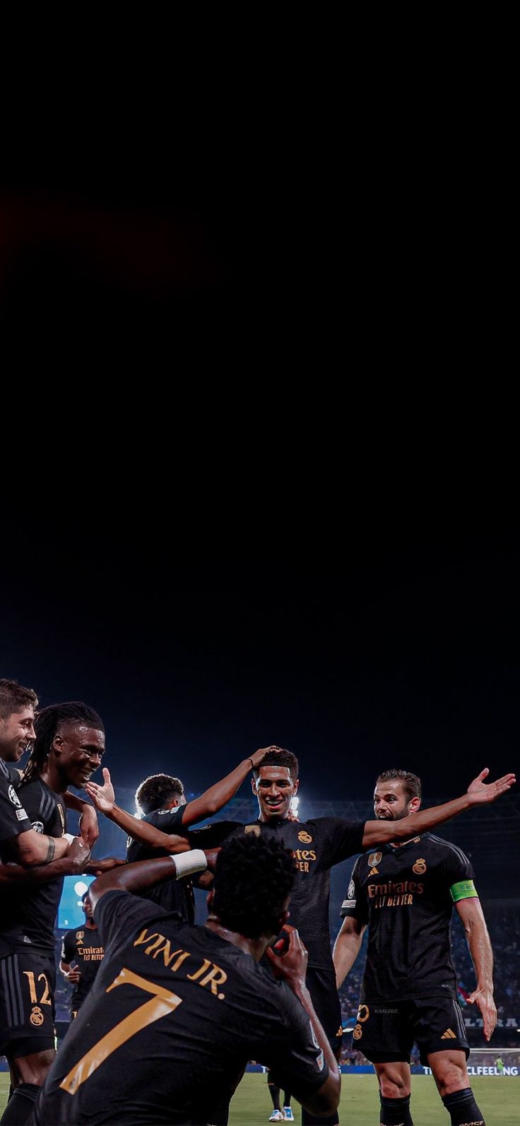 a group of men standing on top of a soccer field