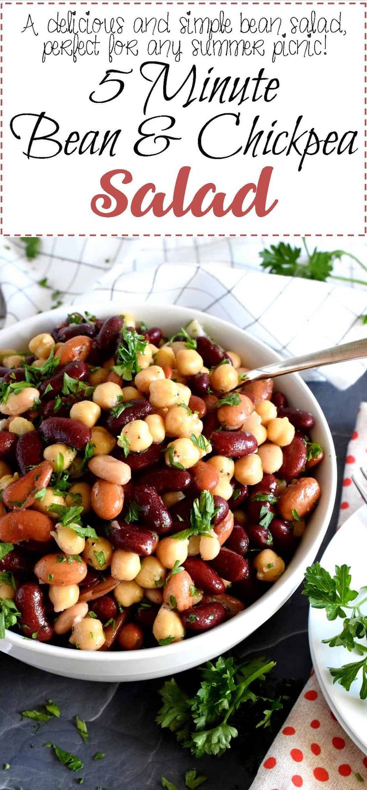 bean and chickpea salad in a white bowl with parsley on the side