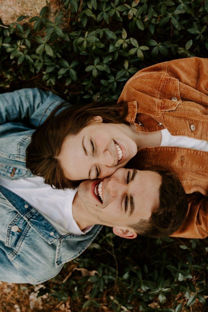 two people laying on the ground smiling