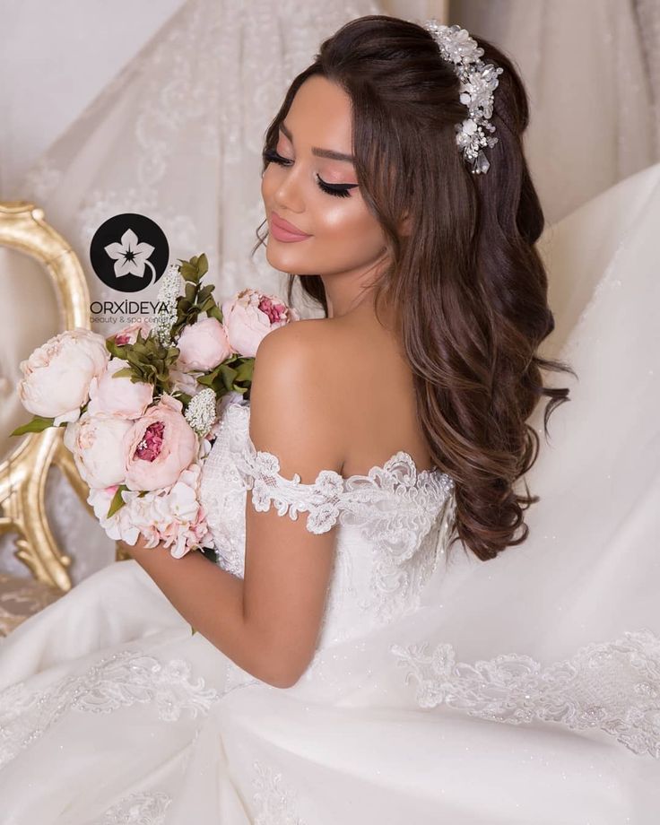 a woman in a wedding dress holding flowers