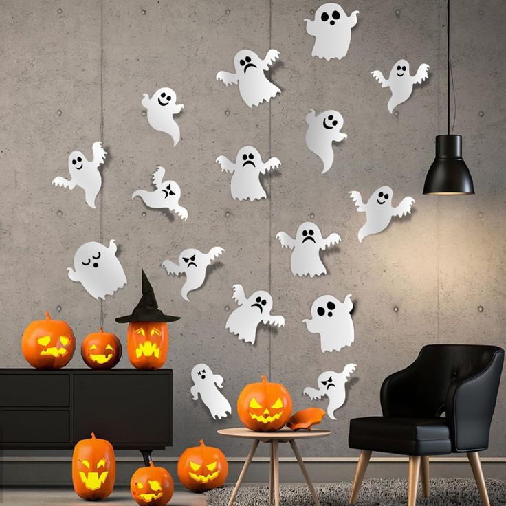 a room filled with lots of fake pumpkins and ghost faces on the wall behind them