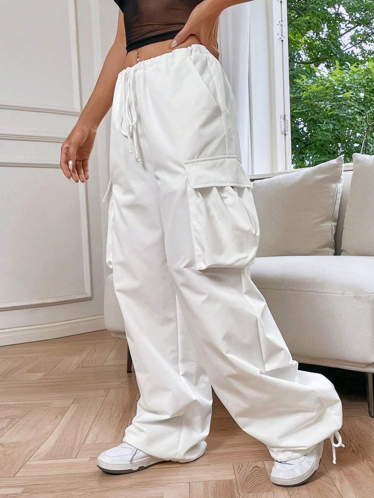 Embrace laid-back sophistication with our Loose Line Cargo Pants. Designed with a drop waist and a loose fit, these pants offer a contemporary twist to your wardrobe. The non-stretch woven fabric ensures longevity, while the drawstring and pocket details add functionality. Specifications: Details: Drawstring, Pocket Waist Line: Drop Waist Length: Long Fit Type: Loose Fabric: Non-Stretch Material: Woven Fabric Composition: 100% Polyester Care Instructions: Hand wash or professionally dry clean Si Wide Leg Cargo Style Loungewear Pants, Spring Straight Cargo Pants With Loose Fit, Spring Cargo Pocket Wide Leg Sweatpants, Spring Cargo Style Wide Leg Harem Pants, Spring Wide Leg Sweatpants With Cargo Pockets, Versatile White Bottoms With Pockets, Relaxed Fit Wide Leg Cargo Sweatpants, Casual White Cargo Pants With Loose Fit, Wide Leg Summer Sweatpants With Cargo Pockets