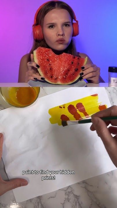 a girl eating a watermelon slice with earphones on her head and another person holding a piece of food in front of her face