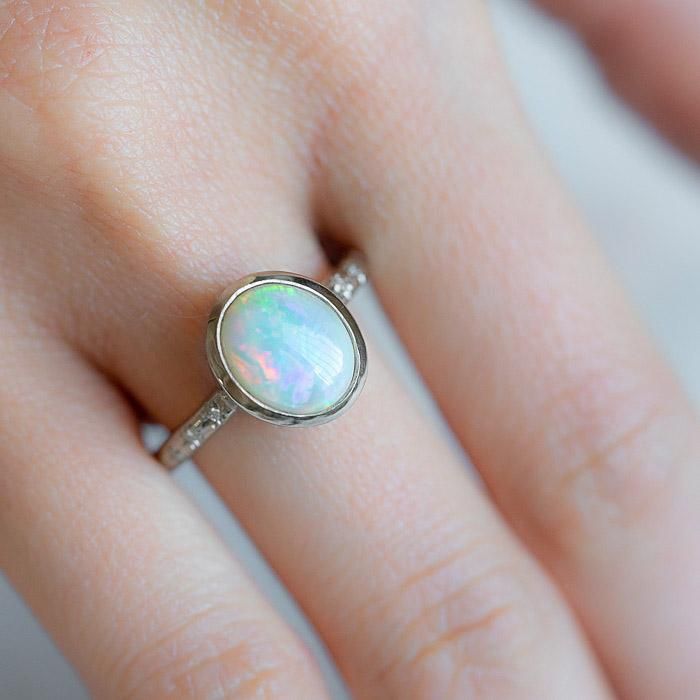 Our Twilight Ring has been set with a crystal opal and G/VS diamonds star set into the band. Opals are the birthstone of October. Opal measures 9 x 7mm. Total diamond weight 0.03ct. Band width 2.2mm. Pictured here with a high shine finish. For a matte finish please leave a note at checkout. Please note, we will match the opal as close to the image as possible. Each opal is unique and may vary in appearance and colour from what is depicted on the site. Classic Ethiopian Opal Gemstone Rings, Classic Opal Rings With Birthstone, Fine Jewelry Opal Oval Cabochon Ring, Fine Jewelry Opal Ring Oval Cabochon Birthstone, Ethiopian Opal Birthstone Rings, Oval Opal Rings With Bezel Setting, Oval Ethiopian Opal Birthstone Ring, Opal Birthstone Ring Oval Cabochon, Fine Jewelry Ethiopian Opal Birthstone Rings