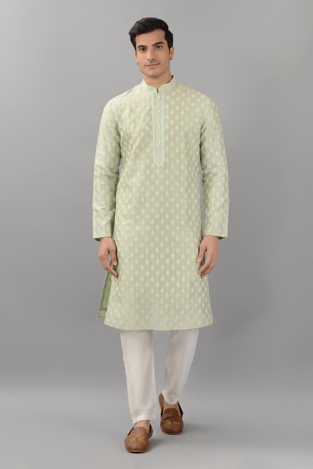 Pistachio green silk kurta with mandarin collar, all over floral butti pattern and thread embroidery. Paired with white straight fit pants.
Components: 2
Pattern: Embroidered
Type Of Work: Thread Work
Neckline: Mandarin Collar
Sleeve Type: Full Sleeves
Fabric: Silk
Color: Green
Other Details: 
Embroidered collar and placket
Side slits on kurta
Kurta Closure: Front button placket
Occasion: Mehendi and Puja,Sangeet - Aza Fashions Kurta Set For Men, Straight Fit Pants, Types Of Work, Silk Kurta, Embroidered Collars, Pistachio Green, Thread Embroidery, Thread Work, Fabric Silk