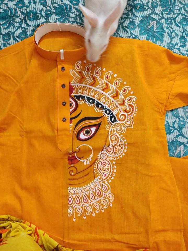 an orange shirt with a painting on it