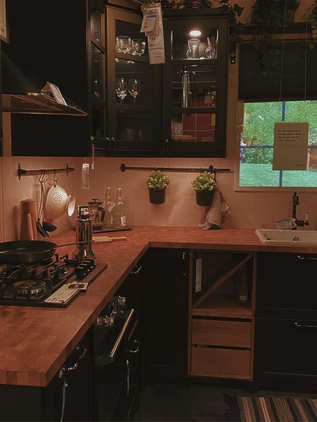 a kitchen counter with pots and pans on top of it next to a window