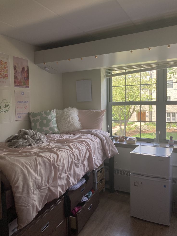 a bedroom with a bed, desk and window