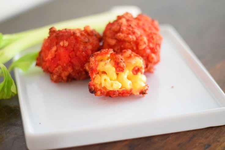 two pieces of food on a white plate with celery sticks in the background