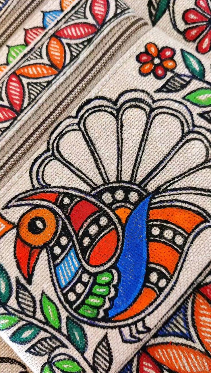 an intricately painted piece of cloth with flowers and leaves on the edges, depicting a bird