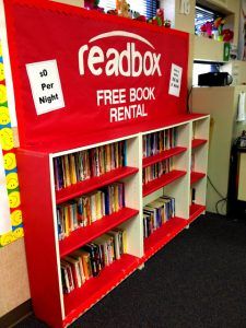 a red and white bookcase with free books on it in a room filled with children's toys