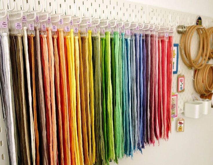 there are many different colored papers hanging on the wall