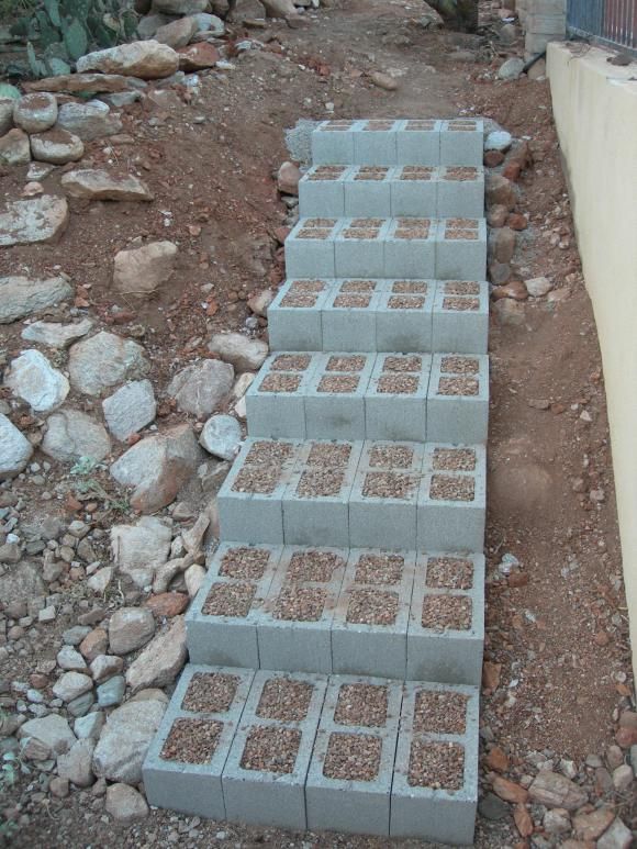 several cinder blocks stacked on top of each other in the middle of a dirt field