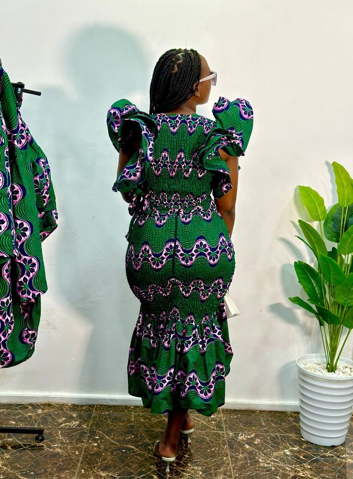 Dali Shirred African Print Ruffled Crop Top - Green - | Sellox Fitted Midi Dress With Ruffles, Chic Midi Dress With Ruffles, Summer Midi Dress With Ruffled Skirt, Fitted Midi Dress With Ruched Tiered Skirt, Stretch Ruffle Long Dress, Long Stretch Dress With Ruffles, Fitted Maxi Skirt With Ruched Detail, Stretch Midi Dress With Smocked Bodice, Green Fitted Midi Dress With Smocked Bodice