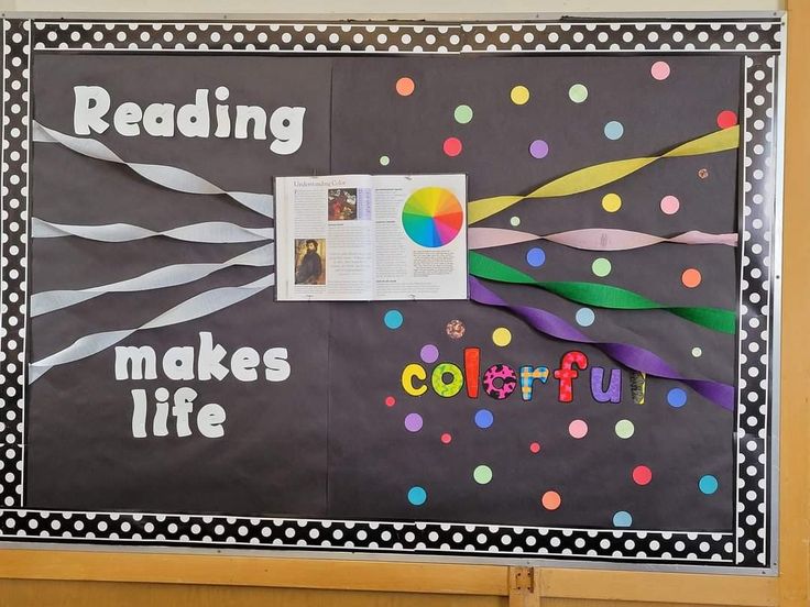 a bulletin board is decorated with colorful ribbons