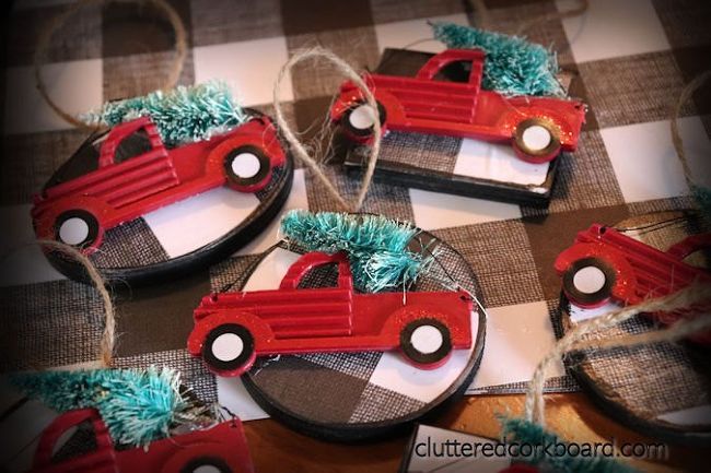 four red cars decorated with blue tinsel on top of a checkered table cloth