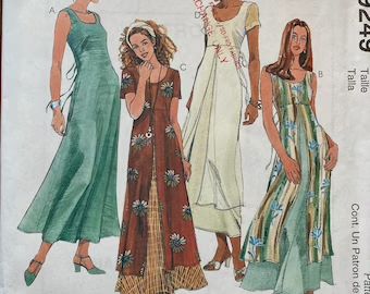 three women in dresses and sandals, one wearing a dress with buttons on the side