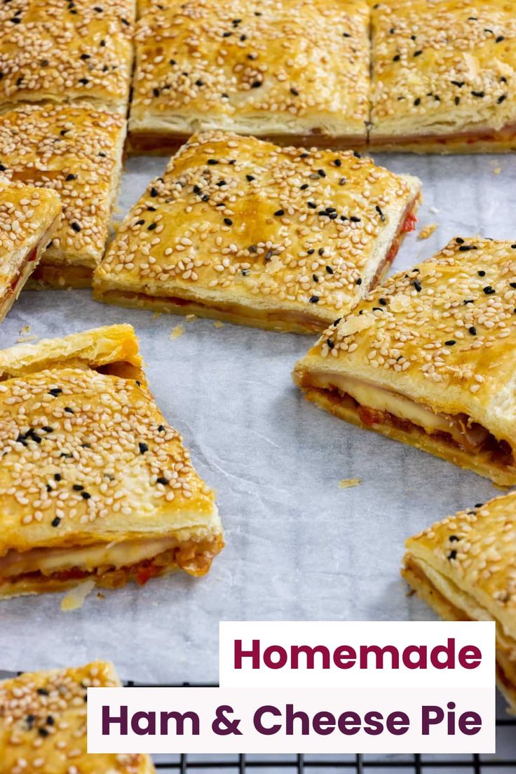 there are many small sandwiches on the trays ready to be baked in the oven