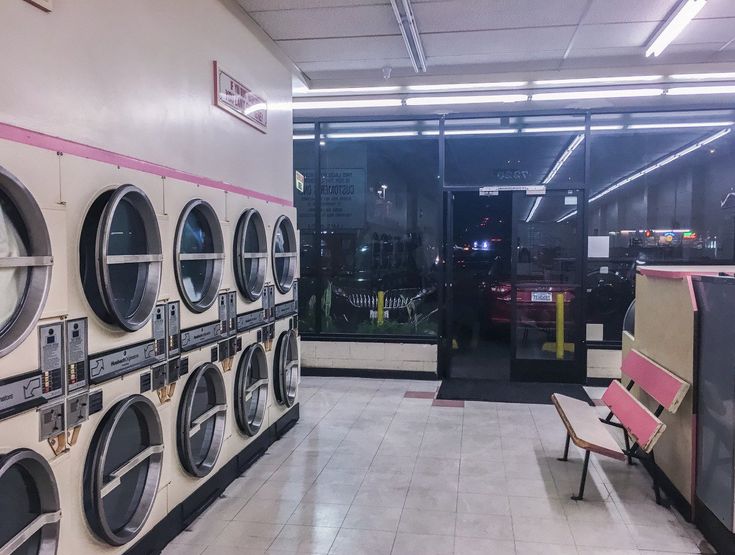 a row of washers sitting next to each other in a room