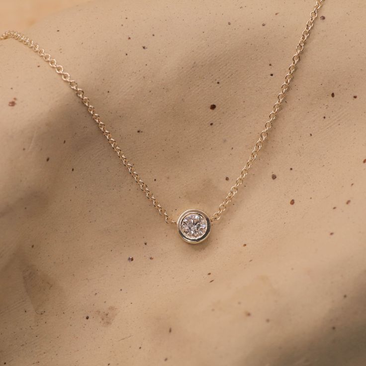 Our Margarita necklace has an elegant round pendant and the center is a large white diamond. This stunning and stylish design adds a touch of glamour to any look whether you're a bride or just want to dress up your casual attire. This classic timeless pendant will never go out of style and you're sure to enjoy it for many years to come. All features can be customized! Talk to us, we love making custom designs. Our jewelry is carefully handmade in our atelier Our diamonds are conflict free To order by phone click here>> +972(0)722991000 Elegant 14k Gold Birthstone Pendant Necklace, Elegant 14k Gold Pendant Birthstone Necklace, Minimalist Round Cut Bezel Setting Necklace, Elegant Yellow Gold Diamond Cut Birthstone Necklace, Elegant Round Diamond Necklaces, Timeless Round Necklace For Wedding, Timeless Round Wedding Necklaces, Fine Jewelry Diamond White Necklaces With Round Stone, Classic White Necklace With Bezel Setting