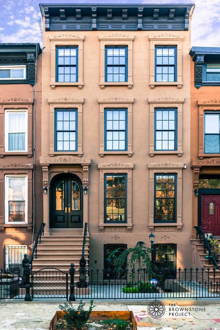 an apartment building with many windows and stairs