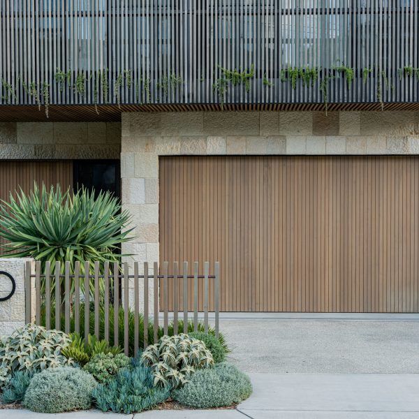 a bike parked in front of a building with two garage doors on the opposite side