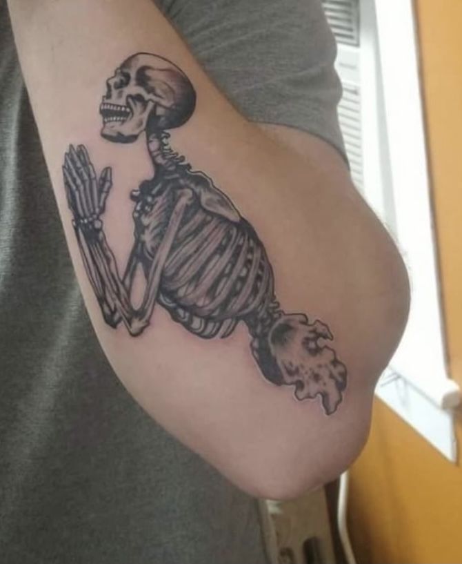 a man with a skeleton tattoo on his arm