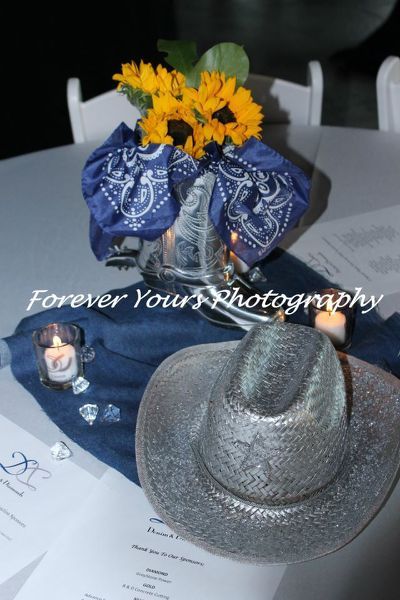 a hat is sitting on top of a table next to a bouquet of sunflowers