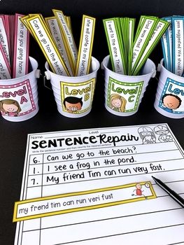 some cups with pens and pencils sitting on top of a table next to papers