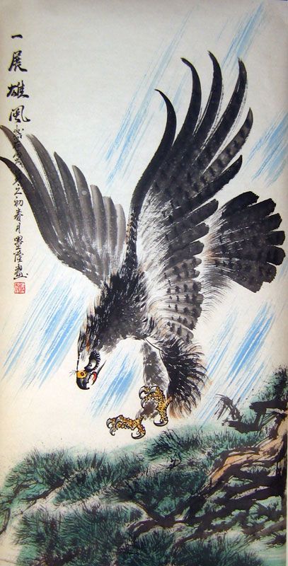 an eagle flying over a tiger on top of a hill