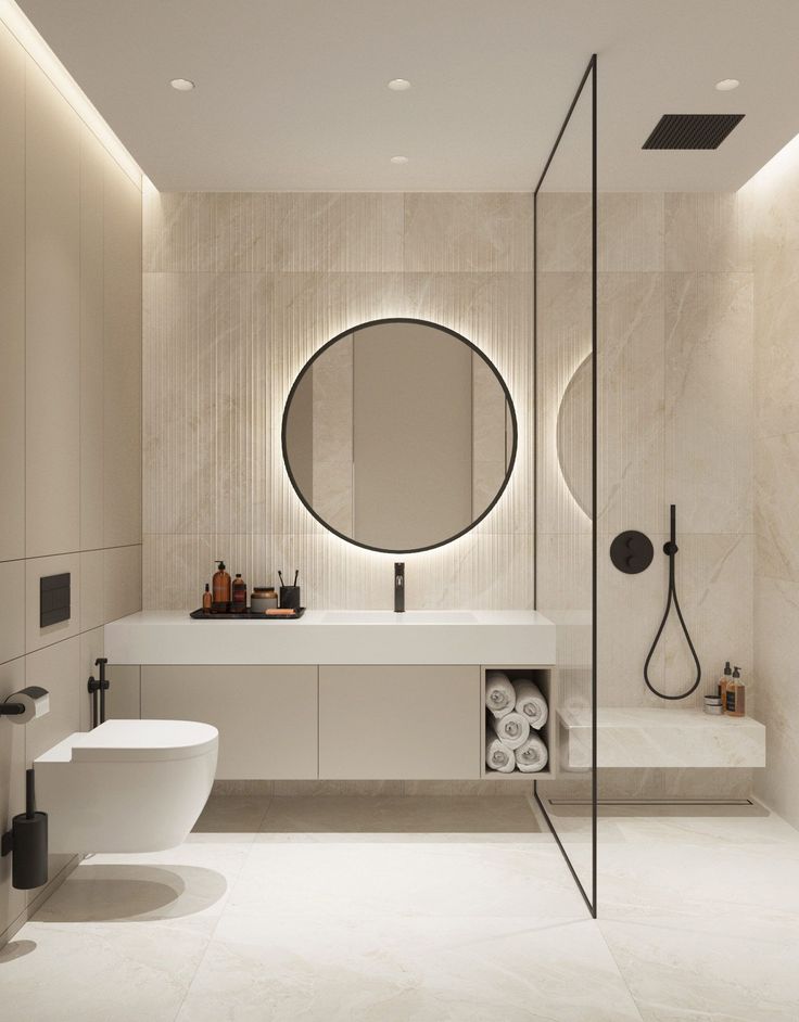 a modern bathroom with a round mirror above the sink