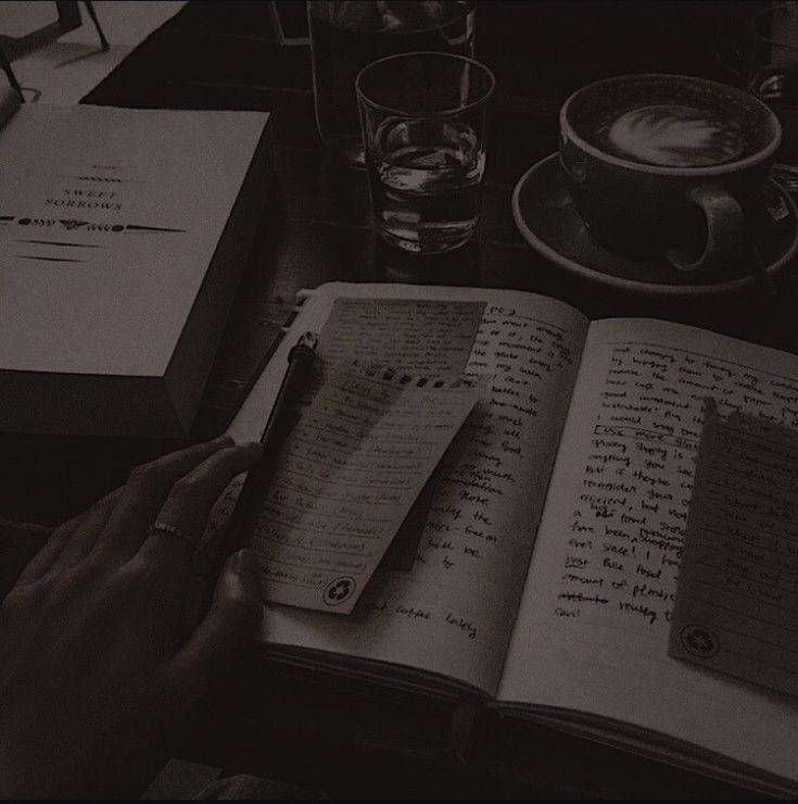 a person sitting at a table with an open book