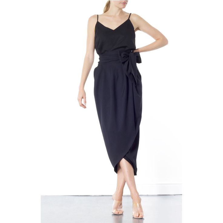 The Blake Tulip skirt is super flattering on any size. Coming in one size fits all, this wrap-around tulip style is designed to sit high on the waist. It's finished with a wrap-around belt that ties at the side, to nip in your waist for a flattering effect. Tie into a bow or leave as it is. This dramatic outline is best complemented with a fitted top. Hand wash recommended Wash with like colours to avoid colour transfer Press on reverse side Iron on low heat  100% polyester Plum Midi Dress, Black Tulips, Tulip Skirt, Fitted Top, Independent Designers Fashion, Work Outfits, Wrap Skirt, Badger, Modern Woman