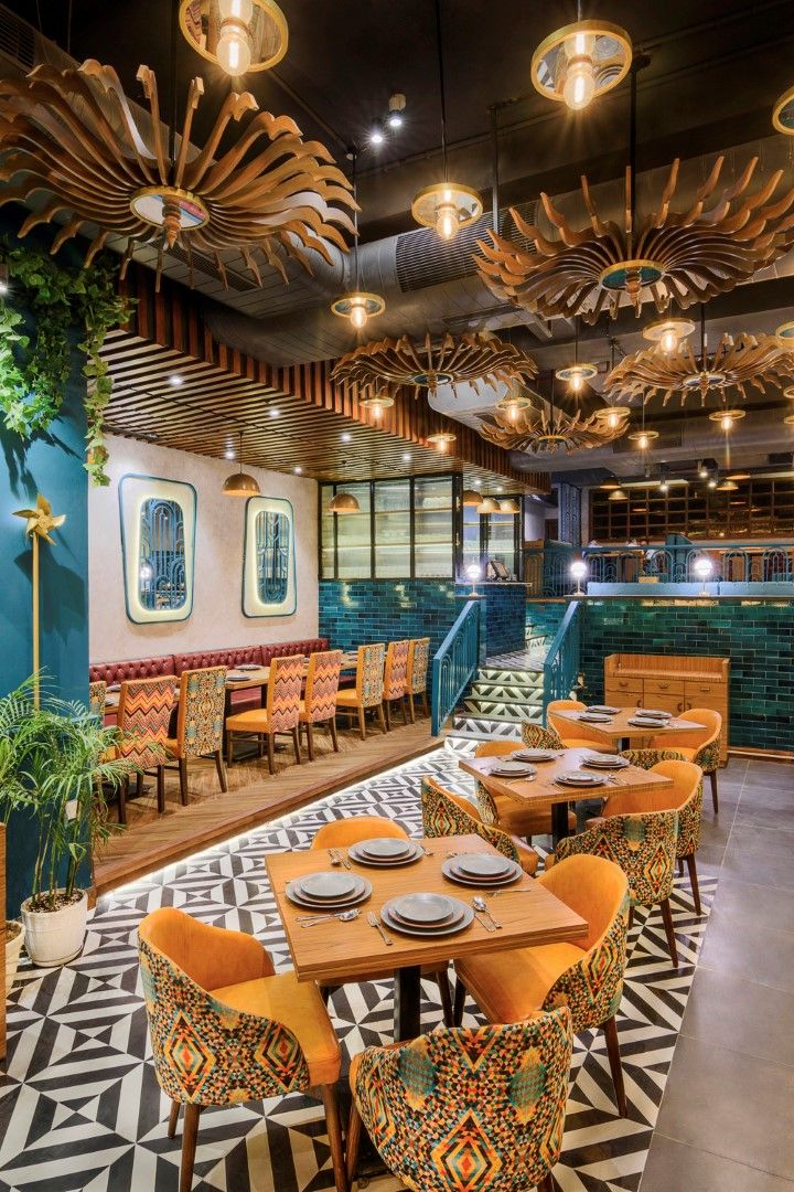 the interior of a restaurant with tables and chairs