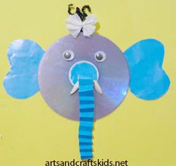 an elephant made out of paper with blue and white stripes on it's head